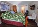 Comfortable bedroom featuring hardwood floors and an adjacent bathroom at 3917 Lake Bayshore Dr # F-307, Bradenton, FL 34205
