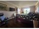 Bright bedroom with hardwood floors, decorative seating, and attached TV at 3917 Lake Bayshore Dr # F-307, Bradenton, FL 34205