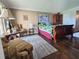 Spacious bedroom with hardwood floors, crown molding, and a decorative accent chair at 3917 Lake Bayshore Dr # F-307, Bradenton, FL 34205