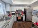 Modern kitchen with stainless steel appliances, granite countertops, and a stylish backsplash at 3917 Lake Bayshore Dr # F-307, Bradenton, FL 34205