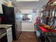 Well-lit kitchen with stainless steel refrigerator and a pass-through to dining area at 3917 Lake Bayshore Dr # F-307, Bradenton, FL 34205
