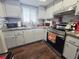 Updated kitchen featuring stainless steel appliances, stone countertops, and shaker-style cabinets at 3917 Lake Bayshore Dr # F-307, Bradenton, FL 34205
