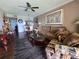 Bright living area showcasing hardwood floors, ample seating, and a seamless connection to the dining space at 3917 Lake Bayshore Dr # F-307, Bradenton, FL 34205