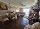 Cozy living and dining area features hardwood floors, slider to the balcony and ceiling fan at 3917 Lake Bayshore Dr # F-307, Bradenton, FL 34205