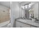 Bathroom features granite vanity, updated fixtures, and tiled shower with tub at 400 E Baffin Dr, Venice, FL 34293