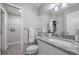Clean and modern bathroom featuring a granite countertop, a sink, and a shower with a glass door at 400 E Baffin Dr, Venice, FL 34293