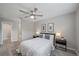 Bedroom with neutral walls, ceiling fan, and a window letting in natural light at 400 E Baffin Dr, Venice, FL 34293