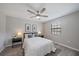 Bedroom with neutral walls, ceiling fan, and a window letting in natural light at 400 E Baffin Dr, Venice, FL 34293