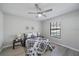 Well-lit bedroom featuring a ceiling fan, a large window, and neutral decor for a tranquil ambiance at 400 E Baffin Dr, Venice, FL 34293