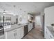 Open kitchen with stainless steel appliances, granite countertops, and an open view to the dining area at 400 E Baffin Dr, Venice, FL 34293