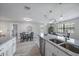 Open kitchen featuring granite countertops, a stainless steel dishwasher, and an eat-in dining area at 400 E Baffin Dr, Venice, FL 34293