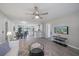 Inviting living room featuring hardwood floors, a ceiling fan, and an open layout to the dining area at 400 E Baffin Dr, Venice, FL 34293