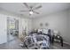 Cozy bedroom featuring a ceiling fan, mirrored closet doors, and access to an en-suite bathroom at 400 E Baffin Dr, Venice, FL 34293