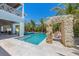 Lush backyard oasis with a shimmering pool, rock feature, and lounge chairs, creating a perfect setting for relaxation at 401 39Th St, Holmes Beach, FL 34217