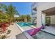 Lush backyard oasis featuring a sparkling pool, lounge chairs, and vibrant tropical foliage for the ultimate relaxation at 401 39Th St, Holmes Beach, FL 34217