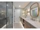 Modern bathroom features double sinks, stylish mirrors, and a glass enclosed shower at 401 39Th St, Holmes Beach, FL 34217