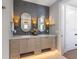 Bathroom featuring a double vanity with stone countertops and decorative lighting fixtures at 401 39Th St, Holmes Beach, FL 34217