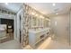 Contemporary bathroom featuring double sinks, a frameless glass shower, and patterned wallpaper at 401 39Th St, Holmes Beach, FL 34217