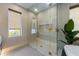 Upscale bathroom featuring a walk-in shower and tub with stylish gold fixtures and a decorative pebble floor at 401 39Th St, Holmes Beach, FL 34217