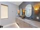 Spa bathroom featuring double vanities, stylish sconces, and unique oval mirrors at 401 39Th St, Holmes Beach, FL 34217