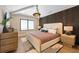 Bright bedroom boasts hardwood floors, recessed lighting, and a dark wood slat accent wall at 401 39Th St, Holmes Beach, FL 34217