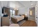 Bright bedroom boasts hardwood floors, a tray ceiling, and a balcony with views at 401 39Th St, Holmes Beach, FL 34217