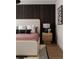 Cozy bedroom features a wood slat accent wall and unique decor at 401 39Th St, Holmes Beach, FL 34217