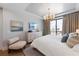 Well-lit bedroom features hardwood floors, a large window, and neutral decor at 401 39Th St, Holmes Beach, FL 34217