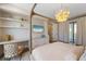 Bright bedroom with a decorative chandelier, modern furnishings, built-in storage, and a walk out to a deck at 401 39Th St, Holmes Beach, FL 34217