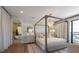 Bedroom with four poster bed, chandelier and attached bath with soaking tub at 401 39Th St, Holmes Beach, FL 34217