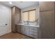 Butler's pantry with custom wood cabinets, marble countertop, and sink by a window at 401 39Th St, Holmes Beach, FL 34217