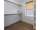 Walk-in closet with built-in shelving, natural light, and hardwood floors at 401 39Th St, Holmes Beach, FL 34217