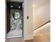 Residential elevator opens next to a staircase with integrated lighting for a modern touch at 401 39Th St, Holmes Beach, FL 34217