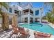 Beautiful home exterior with a refreshing pool, outdoor seating, and lush landscaping, ideal for luxurious outdoor living at 401 39Th St, Holmes Beach, FL 34217