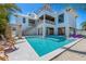 Expansive home exterior with a sparkling pool, manicured landscaping, and luxurious outdoor living areas for relaxation and enjoyment at 401 39Th St, Holmes Beach, FL 34217