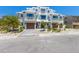 Beautiful modern three-story townhouse with a paver driveway and tropical landscaping at 401 39Th St, Holmes Beach, FL 34217