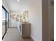 Elegant hallway features a marble-top sideboard with wine fridge and access to an outdoor balcony at 401 39Th St, Holmes Beach, FL 34217