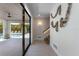 Hallway featuring art piece, stairs and a glass door to the pool area at 401 39Th St, Holmes Beach, FL 34217