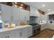 Modern kitchen features marble countertops, stainless steel appliances, and custom cabinets at 401 39Th St, Holmes Beach, FL 34217