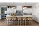 Bright, modern kitchen with white countertops, stylish island seating, and unique pendant lighting at 401 39Th St, Holmes Beach, FL 34217