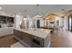 Open-concept kitchen with large island, modern lighting, and seamlessly integrated dining and living areas at 401 39Th St, Holmes Beach, FL 34217