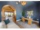 An office with blue walls, wood desk, and a view of an outdoor dining area at 401 39Th St, Holmes Beach, FL 34217