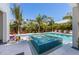 Beautiful backyard featuring a refreshing pool and spa with tropical landscaping, perfect for outdoor entertaining and relaxation at 401 39Th St, Holmes Beach, FL 34217