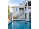 Stunning backyard with a sparkling pool, a modern staircase, and unique architectural details, perfect for outdoor enjoyment at 401 39Th St, Holmes Beach, FL 34217