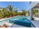 Inviting pool and spa surrounded by lush tropical landscaping, offering a serene backyard retreat for relaxation and enjoyment at 401 39Th St, Holmes Beach, FL 34217