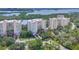 Aerial view of three luxury condominiums with lush landscaping and beautiful architecture at 401 N Point Rd # 504, Osprey, FL 34229