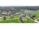 Stunning aerial view of a golf course community with lush greenery, a clubhouse, and waterfront scenery at 401 N Point Rd # 504, Osprey, FL 34229