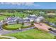 Expansive aerial view of the country club featuring a golf course, lush landscaping and stately architecture at 401 N Point Rd # 504, Osprey, FL 34229