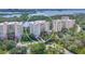 An aerial view of a condo complex showcasing the building's architecture, landscaping, and scenic waterfront location at 401 N Point Rd # 504, Osprey, FL 34229