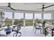 Covered patio with comfortable seating and table for outdoor dining and enjoying scenic views at 401 N Point Rd # 504, Osprey, FL 34229
